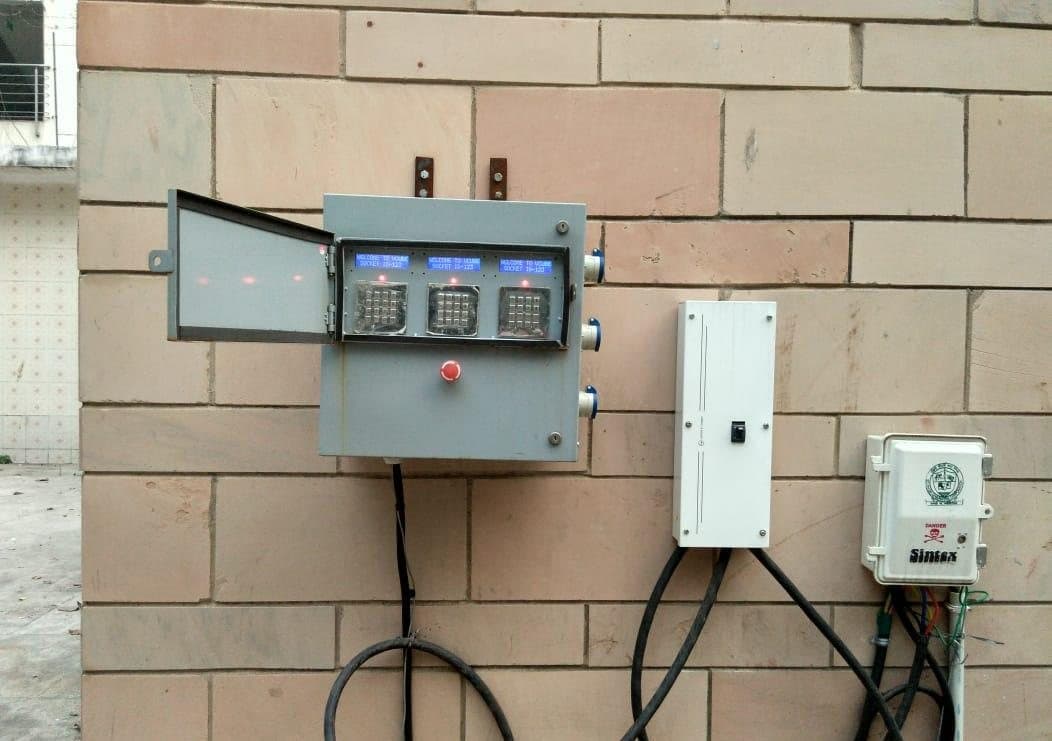 Wall-mounted EVIT three-socket charger with its protection panel